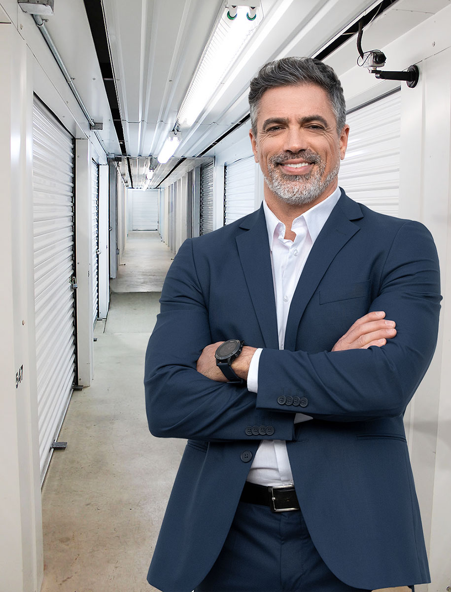 business-man-business-storage Business man in suit with arms crossed standing in the enclosed storage building with climate controlled units